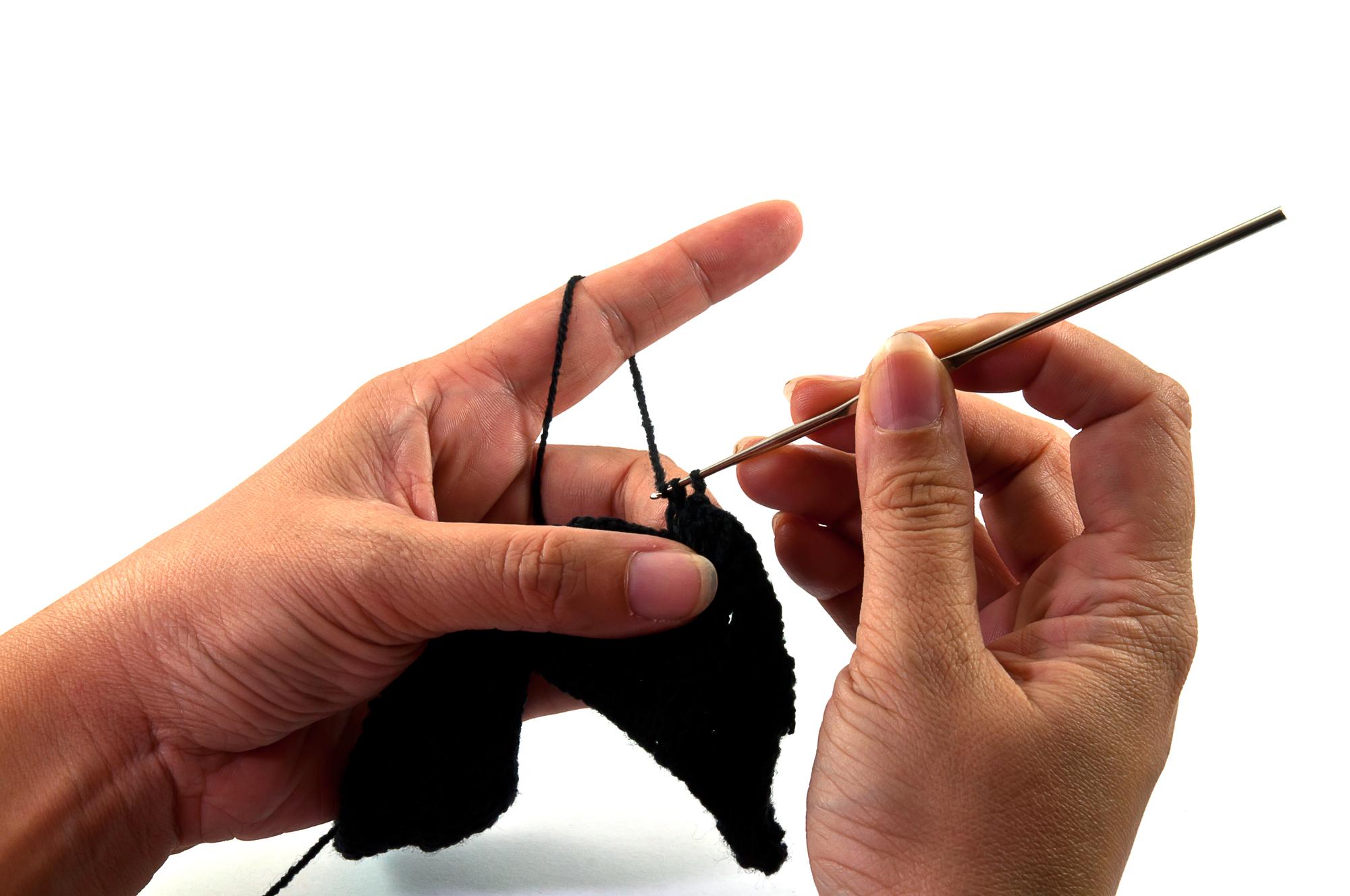 Studio founder stitching a floral motif